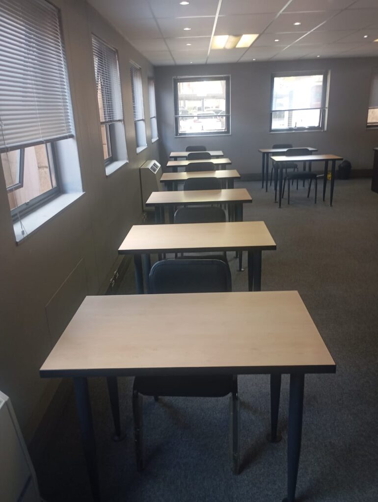 Corporate training room furniture setup with desks and seating