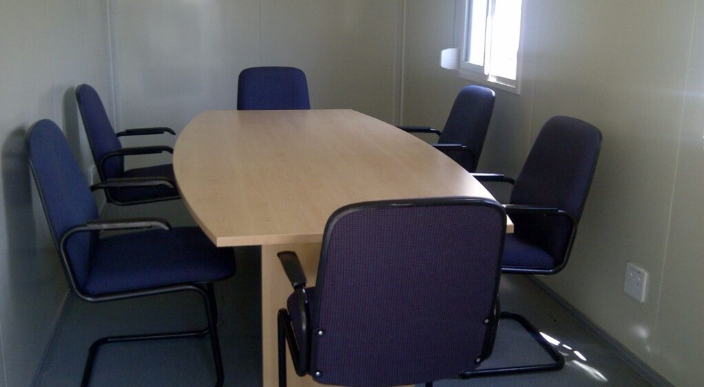 Boardroom table and meeting room chairs setup for a corporate office