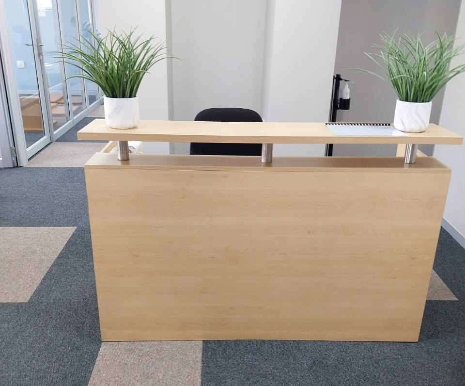 Reception desk and waiting area furniture setup in a corporate office